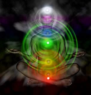 Meditator sitting in the lotus position is showing auric emanations from the seven main energy centres or chakras in the body
