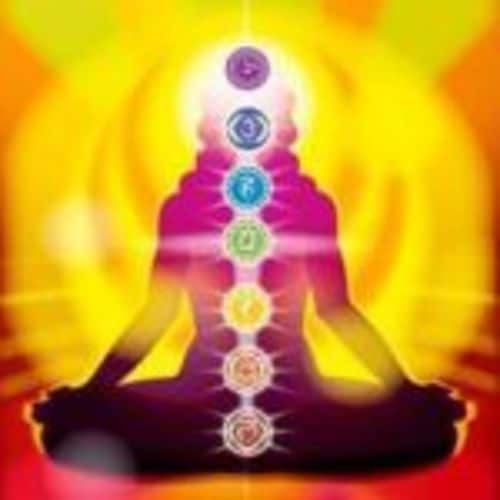 Insight meditation self spiritual healing induces a stronger aura with more vibrant colors. Meditator shows seven chakra energy centers with yellow auric field.