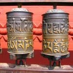 Mantras do not change base rate frequency of being. Prayer wheels are on display at a monastery in Himalayas. A prayer wheel is a symbol for the cycles of life.